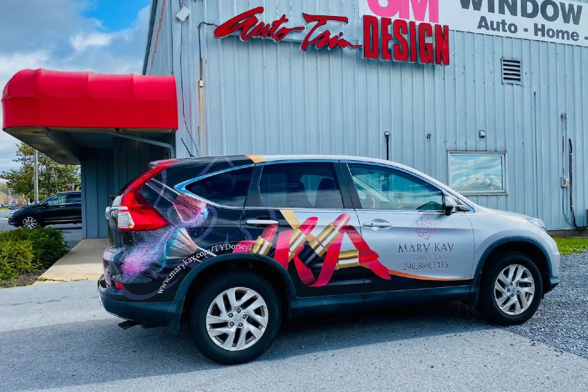 SUV with Mary Kay vehicle branding in front of Auto Trim Design MD